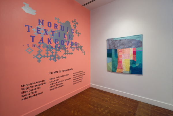 a wall where you can read about the exhibition the cold stitch